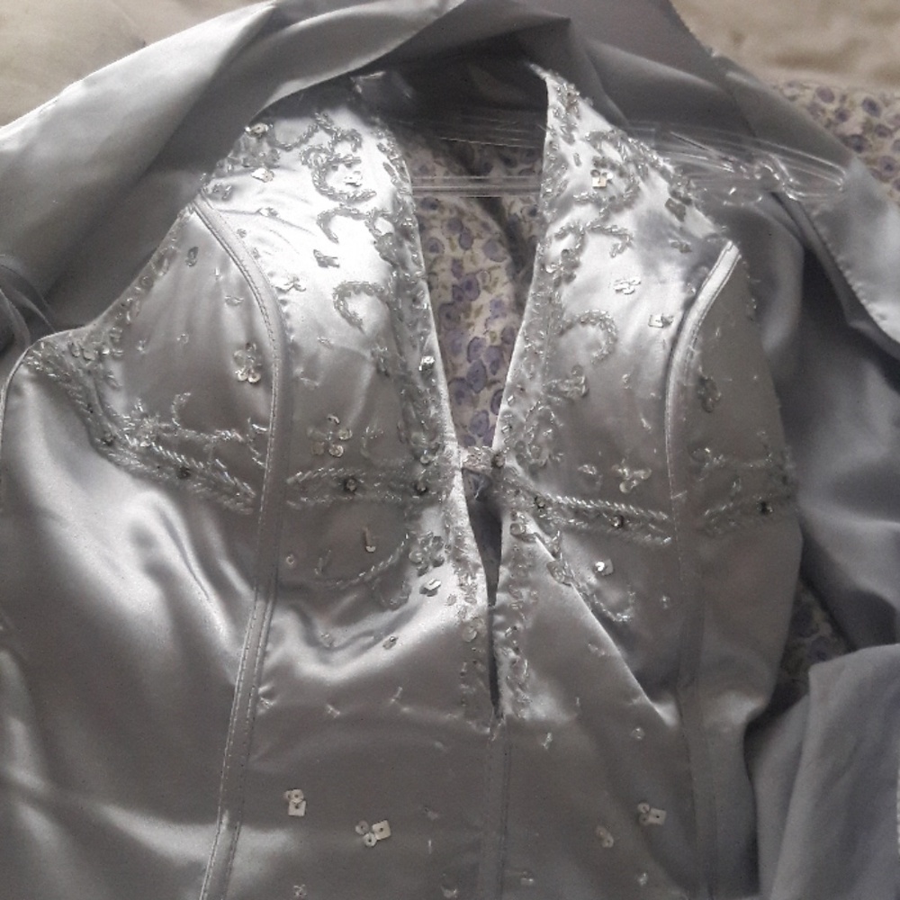 A sliver gown that has intricate beading